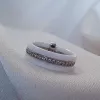 Каблучка срібна з білою керамікою і  цирконієм діамантової огранки 006685